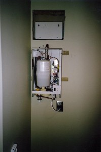 Uncovered steam generator mounted on a wall of a closet